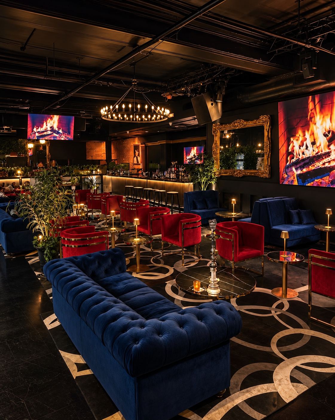 The main lounge: blue chesterfield, red velvet chairs, chandelier and the bar